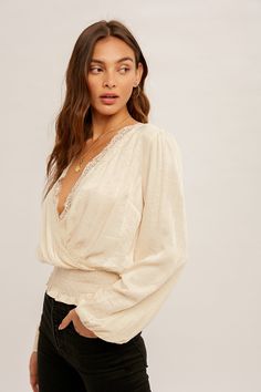 This Amir Blouse is ready to make some serious fashion waves! Crafted from a blend of rayon and polyester, the surplice lace-trimmed smock waist blouse is sure to add a classy and luxe touch to any outfit. Give your wardrobe an upgrade with this must-have piece! Feminine V-neck Tops With Lace Sleeves, Feminine V-neck Lace Top For Day Out, V-neck Blouse With Lace Trim For Brunch, Chic V-neck Lace Top With Lace Trim, V-neck Lace Top For Brunch, Elegant V-neck Lace Top For Brunch, Chic Lace Trim Top For Date Night, Casual V-neck Lace Top With Lace Sleeves, Chic V-neck Lace Top For Fall