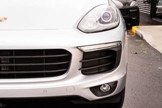 the front end of a white porsche cayen