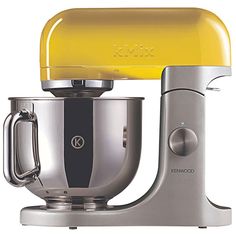 a yellow and silver mixer on a white background