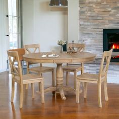 a dining room table with chairs and a fire place