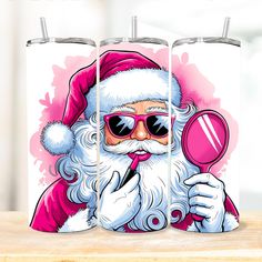 the santa clause is holding a magnifying glass in front of two tumblers