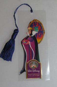 a disney princess ornament with a tassel hanging from it's side