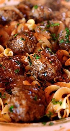 meatballs and noodles are in a bowl on the table