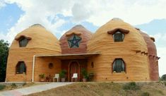 a house made out of clay sitting on top of a hill