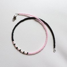 Unique seed bead choker style necklace with an asymmetrical design, made with beautiful pink, matte black and matte white Miyuki beads. Stainless steel lobster claw clasp. This necklace also come in black, white and gold / black, blue  and gold color combinations.  See more seed bead necklaces at my store:  https://www.etsy.com/shop/FayFayJewelry?ref=dashboard-header&section_id=50377409 Visit my store for more unique handmade jewelry pieces: https://fayfayjewelry.etsy.com All Jewelry pieces in t Pink Choker With Round Tiny Beads, Pink Beaded Choker For Gift, Pink Jewelry With Adjustable Black Beads, Adjustable Pink Single Strand Beaded Bracelets, Pink Jewelry With Black Beads For Gift, Adjustable Pink Single Strand Beaded Bracelet, Adjustable Single Strand Pink Beaded Bracelet, Pink Tiny Beads Choker Necklace, Handmade Pink Choker With Round Beads