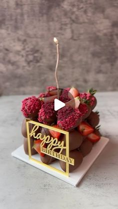 a happy birthday cake with strawberries on it