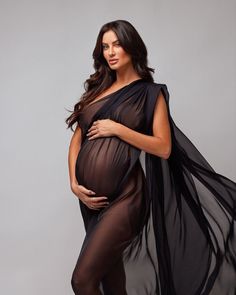 a pregnant woman is posing for a black and white photo