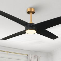 a ceiling fan in a white room with black and gold blades on it's blades