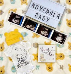 baby items laid out on a blanket next to a sign that says, november baby