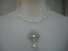 "Beautiful necklace features a beautiful art deco rhinestone pendant set on antique silver plated filigree with dangling pearl hang on a sterling silver chain. The other strand made with hand wire wrapped creamy white swarovski pearls. Finished with a sterling silver clasp with 1.5\" extension chain. Pendant measures about 1.5\" x 2.25\"  Necklace can be made in WHITE Swarovski pearls - If you prefer white pearls, contact me or leave a note at check out.  For full Ava Collection, please check he Necklace Art Deco, Necklace Art, Necklace Bridal, Vintage Style Wedding, Swarovski Pearls, Necklace Vintage, Bridal Necklace, Style Wedding, Pricing Jewelry