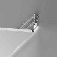 the corner of a wall with metal bars on it and light coming from underneath, against a gray background