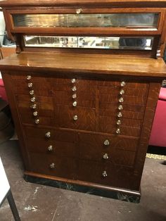 an old dresser with many drawers and knobs