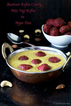 beetroot kofta curry in apple pan with cashews on the side