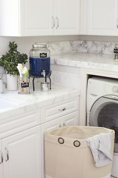 a washer and dryer in a room with marble counter tops on the floor