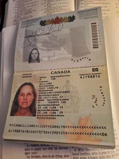 two canadian id cards sitting on top of an open book