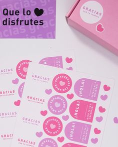 three pink stickers with hearts on them next to a package of bracias