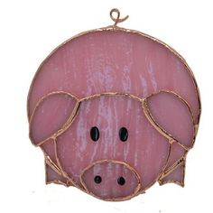 a pink pig hanging on a white wall