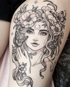 a woman's face with flowers and butterflies in her hair, on the thigh