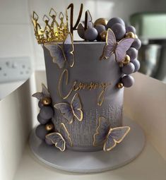 a cake decorated with purple and gold butterflies