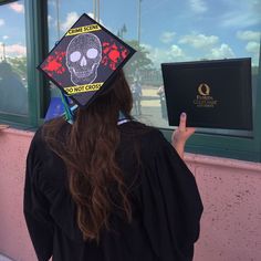 a person wearing a graduation cap with a skull on it