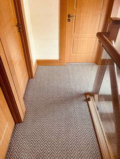 an empty room with wooden doors and carpet