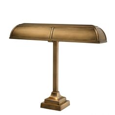 a brass colored lamp on a white background