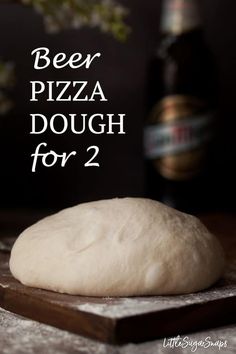 a close up of a dough on a cutting board with text overlay reading beer pizza dough for 2