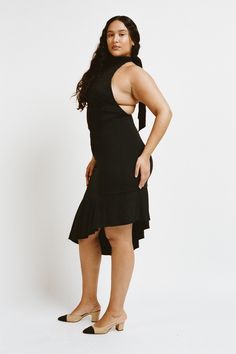 Introducing the Karina dress, in Black. This backless maxi-dress features an asymmetrical hem and halter tie top. Made for a tight fit, she's the perfect cocktail dress. Take her out on the town. True to size. Please refer to the flat-lay image for product accuracy. Fitted Halter Neck Asymmetrical Dress For Party, Fitted Asymmetrical Halter Neck Dress For Party, Chic Low Back Maxi Dress For Night Out, Chic Halter Dress With Low Back For Date Night, Black Low Back Dress With Tie Back, Stretch Midi Dress With Tie Back For Night Out, Black Dress With Low Back And Tie Detail, Black Dress With Tie Back And Low Back, Chic Low Back Halter Dress For Date Night