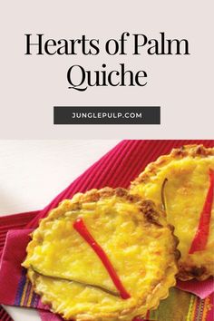 two heart shaped quiche on top of a red and yellow towel with the words hearts of palm quiche