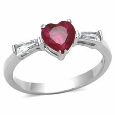 a red heart shaped ring with two baguets on the side and an inscription that says