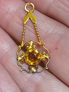 Beautiful vintage art deco glass citrine pendant. The color brassy tone. Discoloration at the bottom edge,and on back discolor. Very light delicate piece. This is not gold. Only a metal base. See photos for measurements. Any questions or concerns please ask. I will be most helpful.  Check out my other shops www.arlettemichelle.etsy.com  www.jmoriginalart.com  www.jmoriginalart.etsy.com Art Deco Citrine Yellow Gold Jewelry, Art Deco Citrine Jewelry In Yellow Gold, Antique Yellow Jewelry Collectible, Gold Hallmarked Art Deco Jewelry, Art Nouveau Gold Necklace With Gemstone, Gold Art Nouveau Necklace With Gemstone, Gold Art Deco Hallmarked Jewelry, Antique Yellow Collectible Jewelry, Gold Art Deco Round Necklace