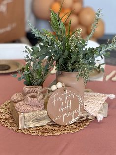 there is a potted plant on top of a table with other items around it