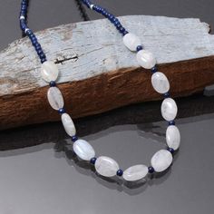 PRODUCT DETAIL :ITEM : MOONSTONE/ LAPIS LAZULI/ PEARL NECKLACEITEM CODE :  DGC3548ITEM NAME :NECKLACEGEMSTONE :  MOONSTONE/ LAPIS LAZULI/ PEARLBEADS SHAPE  : SMOOTH ROUND AND CHIPSLENGTH :   18 INCH APPROXBEADS SIZE:  11.5x9.5mm/3.5mm Approx.WEIGHT :  86 Cts. APPROXCUSTOMIZATION/BULK ORDER : AVAILABLEPLEASE FEEL FREE TO CONTACT IF YOU REQUIRE ANY FURTHER INFORMATION. White Necklaces With Oval Natural Stone Beads, White Necklaces With Oval Natural Stones, White Oval Gemstone Beads Necklaces, White Moonstone Beaded Necklaces With Round Beads, Spiritual Oval Beaded Necklace With Gemstone Beads, Moonstone Gemstone Beads For Jewelry Making, Stone Bead Necklace, Blue Sapphire Bracelet, Round Bead Necklace