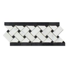 a white and black mosaic tile border with an arrow pattern on the bottom, in two different colors