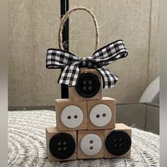 a wooden block tower with buttons and a bow