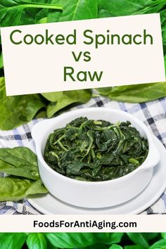 cooked spinach is in a white bowl on top of a blue and white checkered table cloth