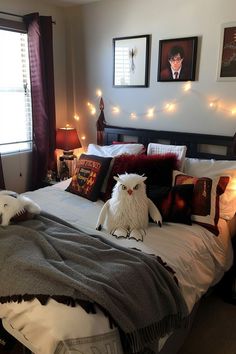 two stuffed animals sit on the bed in a bedroom decorated with lights and pictures above it