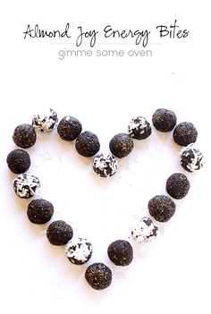 a heart shape made out of black and white rocks with the words, almond joy energy bites