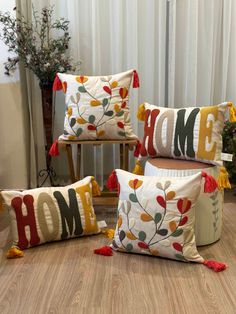 four decorative pillows with the word home on them