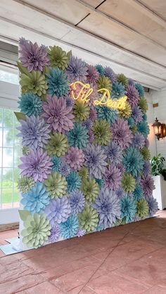 a large flowered wall with the word love spelled on it's centerpiece