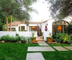 a white house surrounded by greenery and trees