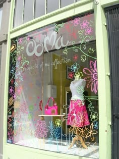 a window display with flowers painted on it