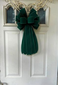 a green bow hangs on the front door