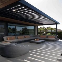 an outdoor living area with couches and tables