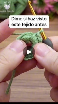 someone is crocheting the end of a piece of green yarn with a needle