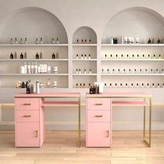 two pink desks in front of shelves with bottles on them