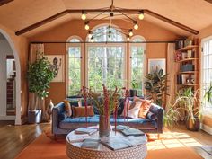 a living room filled with furniture and lots of windows