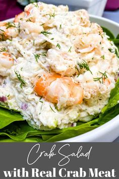 a white bowl filled with shrimp salad on top of lettuce and carrots