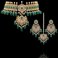 Indulge in the allure of this exquisite jewelry set and let contemporary grace redefine your fashion narrative! Radiate elegance and dangle in delight with our enchanting Esha Set – a mesmerizing blend of elegance and vibrancy meticulously crafted with sparkling zircons, complemented by the refreshing allure of emerald green stones, and embellished with delicately dangling green beads to elevate your style with the perfect harmony of sophistication and playfulness. The set includes a necklace, a maang teekah and a pair of trendy earrings. Approximate earrings length is 3.25". Gold-plated on high-quality brass as base metal. Made by order. Kindly allow 4-6 weeks for the delivery of this item. For custom or urgent requests, please contact support@alacouture.com. *Please Note: We use faux sto Hand Set Jewelry Sets For Reception, Luxury Cubic Zirconia Jewelry Sets For Festive Occasion, Elegant Jeweled Jewelry Sets For Reception, Elegant Festive Sets With American Diamond, Elegant Kundan Hand Set, Bollywood Style Diamond Jewelry With Stone Work, Formal Cubic Zirconia Chandbali Jewelry, Luxury Diamond Jewelry Sets For Festive Season, Elegant Bridal Sets With Crystal Stone Work