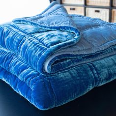 a blue blanket sitting on top of a black table